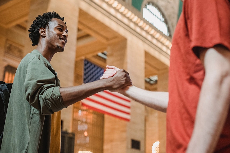 a black man and a white man shaking hands